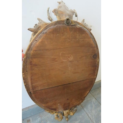 803 - A 19th century oval girandole wall mirror in an ornate gilt gesso surround featuring moulded cornice... 