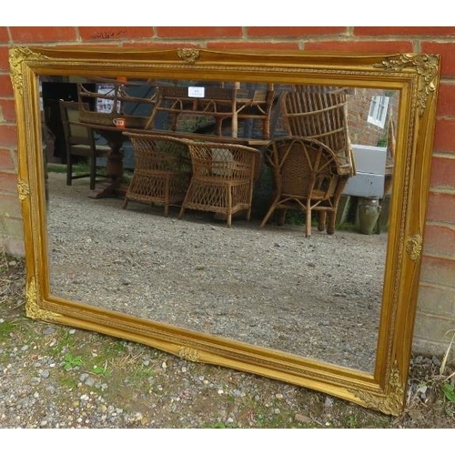 809 - An antique style rectangular bevelled wall mirror, within a gilt gesso moulded surround. Fittings fo... 