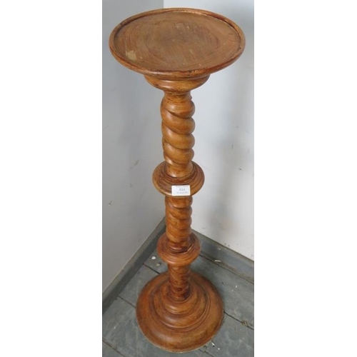 814 - A vintage stained beech torchere, with dished top, on a spiral carved column with stepped plinth bas... 