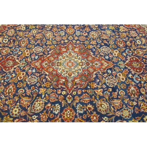 949 - A fine central Persian Kashan carpet. central motif on blue ground and in excellent condition. 335 x... 