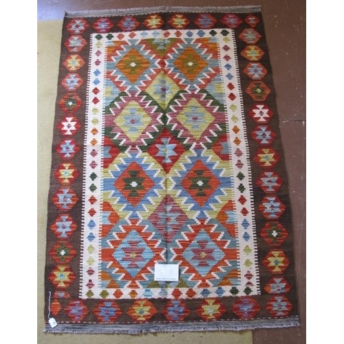 952 - A Chobi Kilim rug. Good strong colours and in very good condition. 158cm x 109cm.