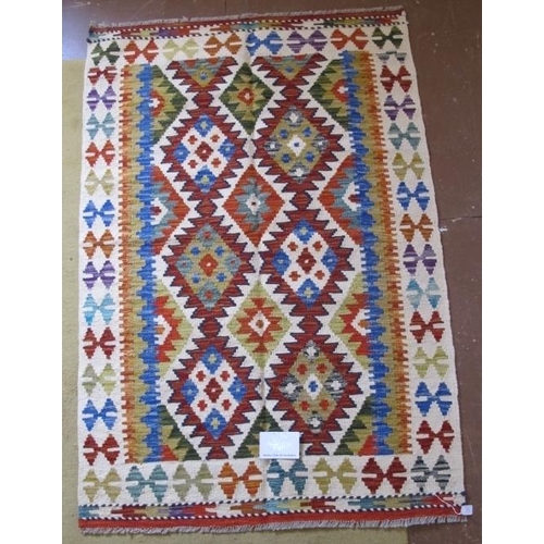 953 - A fine Chobi Kilim rug. Good vibrant colours and in excellent condition. 150cm x 101cm.