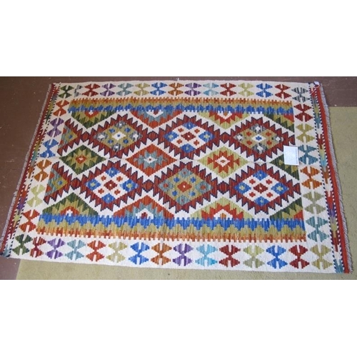 953 - A fine Chobi Kilim rug. Good vibrant colours and in excellent condition. 150cm x 101cm.