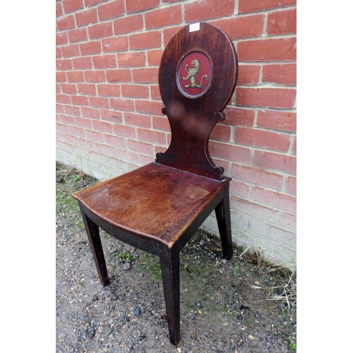 800 - A Georgian mahogany hall chair, the shaped backrest with inset panel hand painted with a rampant lio... 