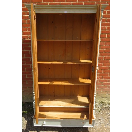 740A - An antique continental pine glazed display cabinet of three loose shelves, flanked by turned pilaste... 