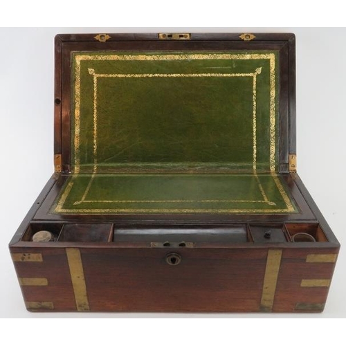 100 - A Victorian rosewood campaign style writing slope. With hidden draw to the side and a hinged cover e... 