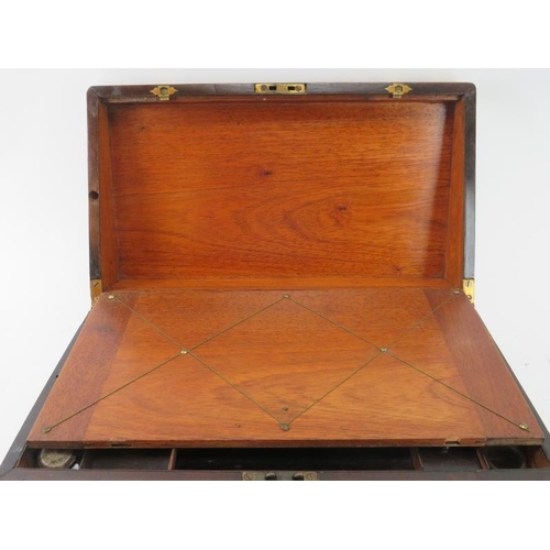 100 - A Victorian rosewood campaign style writing slope. With hidden draw to the side and a hinged cover e... 