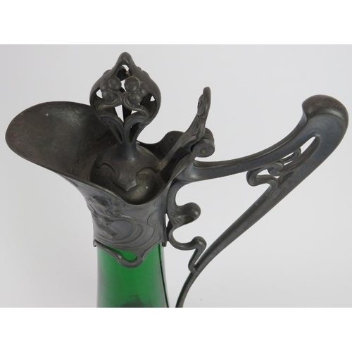 111 - A large WMF Art Nouveau pewter and green glass claret jug designed by Albert Mayer, circa 1900. Cast... 