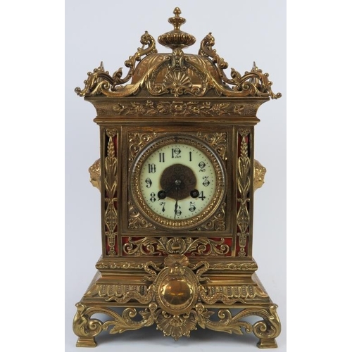 123 - A large ornate European brass mantle clock, 20th century. Pendulum included. 41 cm height.
Condition... 