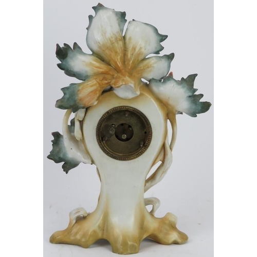 176 - A French Art Nouveau porcelain maiden clock, early 20th century. Modelled with a central clock enclo... 