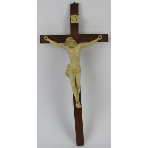 195 - A European ecclesiastical ceramic figure of Jesus on the cross, mid 20th century. Supported on a woo... 