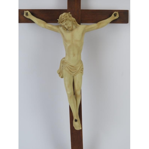 195 - A European ecclesiastical ceramic figure of Jesus on the cross, mid 20th century. Supported on a woo... 