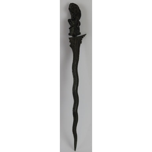 197 - A Japanese ceremonial carved hardwood Kris dagger. Carved with a figural handle and ornately carved ... 