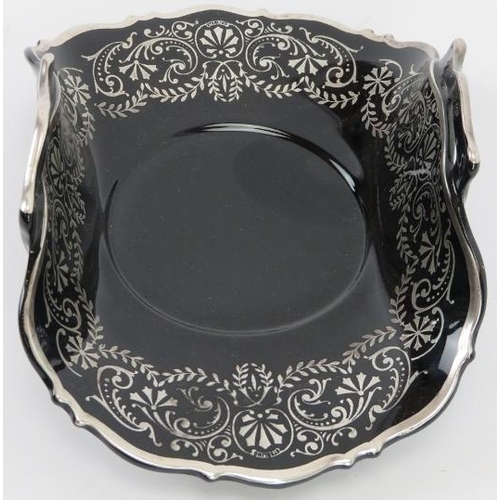 199 - A British twin handled black glass bowl overlaid with foliate sterling silver tracery. ’Sterling’ ma... 