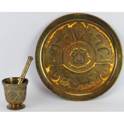 202 - Two Middle Eastern engraved and inlaid brass wares, 20th century. Comprising a circular tray with fo... 