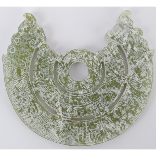 223 - A Chinese celadon jade disc, 20th century. Carved in the style of Shang/Zhou dynasty period examples... 