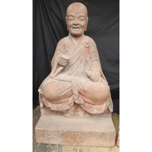 230 - A large architectural pair of Chinese carved red sandstone Luohan guardian monk temple figures. The ... 