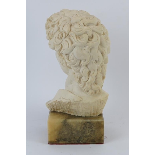 237 - A composite cast bust modelled after Michelangelo’s David, late 20th century. Supported on a faux ma... 