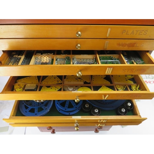 256 - A bespoke cabinet housing large collection of Meccano. The upper eight draws comprehensively named a... 