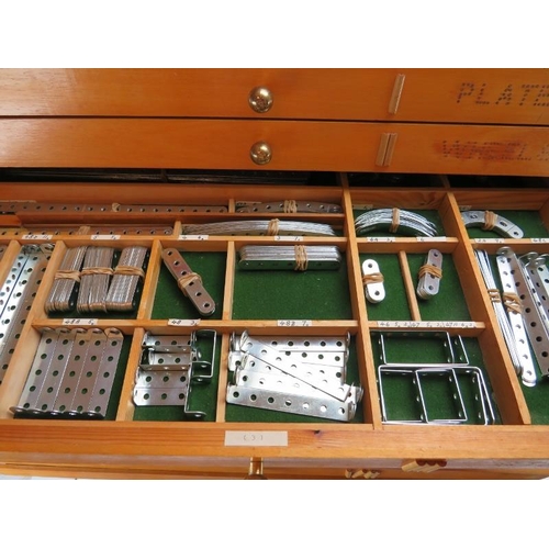 256 - A bespoke cabinet housing large collection of Meccano. The upper eight draws comprehensively named a... 