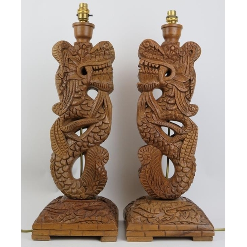 296 - A pair of Oriental style carved wood dragon table lamps, 20th century. (2 items) 55 cm approximate h... 