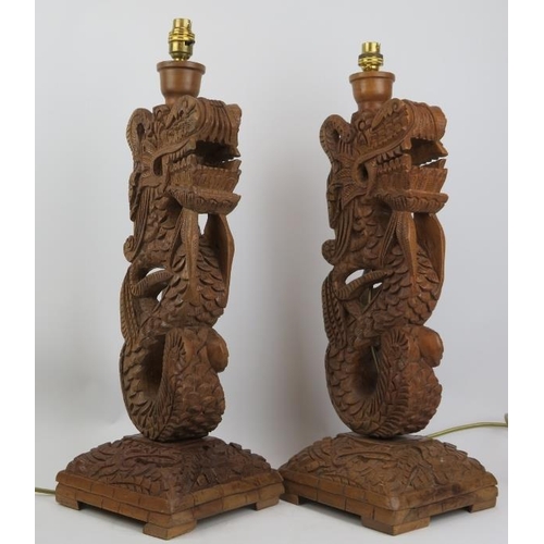 296 - A pair of Oriental style carved wood dragon table lamps, 20th century. (2 items) 55 cm approximate h... 