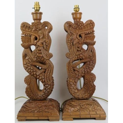 296 - A pair of Oriental style carved wood dragon table lamps, 20th century. (2 items) 55 cm approximate h... 