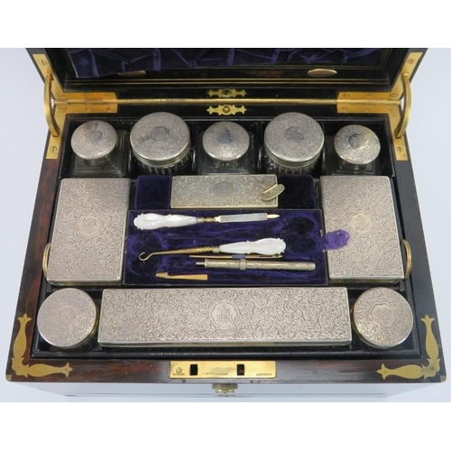 300 - A mid Victorian rosewood and silver mounted glass travelling dressing table set, mid 19th century. F... 