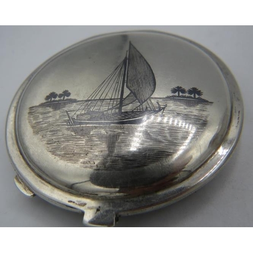 308 - An Iranian Niello & filigree compact with Niello sailing boat on the reverse and inside, 'Abadan 194... 