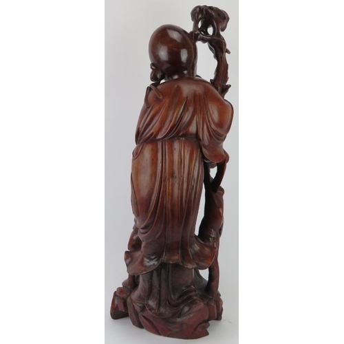 32 - A large Chinese figural hardwood carving of Shou Lao the Chinese God of Longevity, 20th century. 69.... 