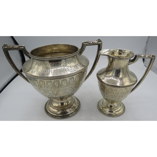 342 - A large Victorian silver sugar bowl and cream jug on pedestal bases, with fine engraving and bead ed... 