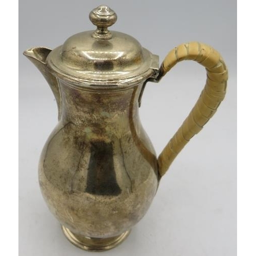 343 - A Victorian silver water jug with bound wicker handle, London 1879. Approx 8