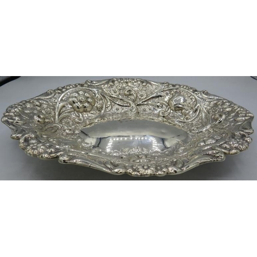 348 - A large oval Victorian silver dish heavily embossed with scrolls & flowers, Sheffield 1886, Elkingto... 