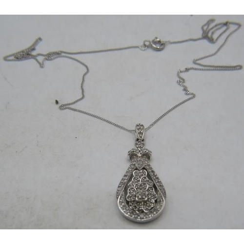 354 - A 9ct white gold pear shaped pendant encrusted with diamonds on a fine white metal chain, clasp mark... 