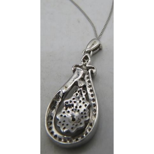 354 - A 9ct white gold pear shaped pendant encrusted with diamonds on a fine white metal chain, clasp mark... 