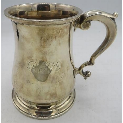 364 - A heavy silver pint tankard with double scroll handle & pedestal foot, Birmingham 1958, monogrammed.... 