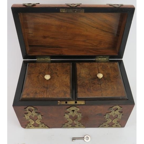 40 - A Victorian brass mounted burr walnut veneered tea caddy. The domed cover with pierced brass mounted... 