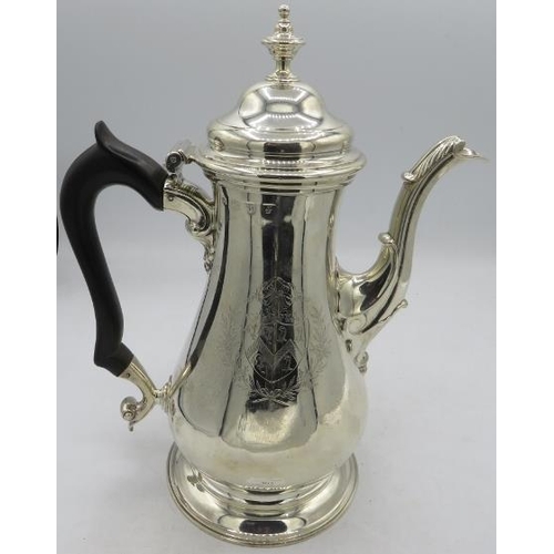 403 - A fine Georgian silver coffee pot sitting on a pedestal foot with acanthus leaf decorated spout and ... 