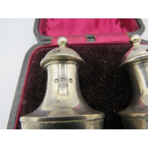 432 - A pair of silver pepper pots with half fluting decoration, Chester 1897, in original box. Approx wei... 