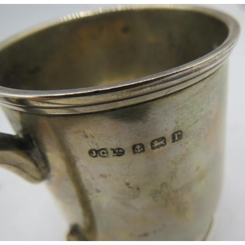 451 - A silver christening mug with plain loop handle sitting on a pedestal foot, Birmingham 1916, monogra... 