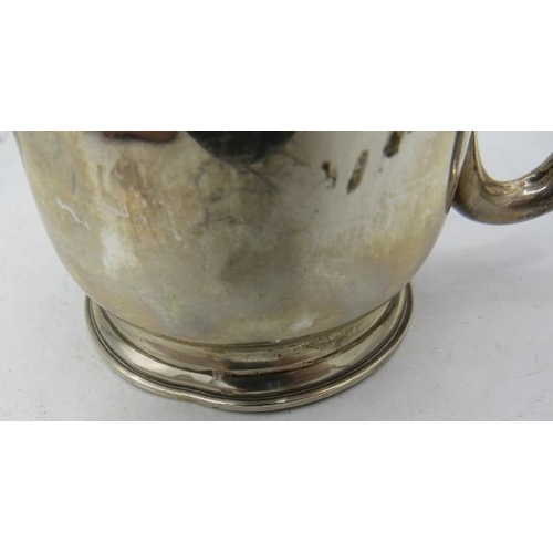 451 - A silver christening mug with plain loop handle sitting on a pedestal foot, Birmingham 1916, monogra... 