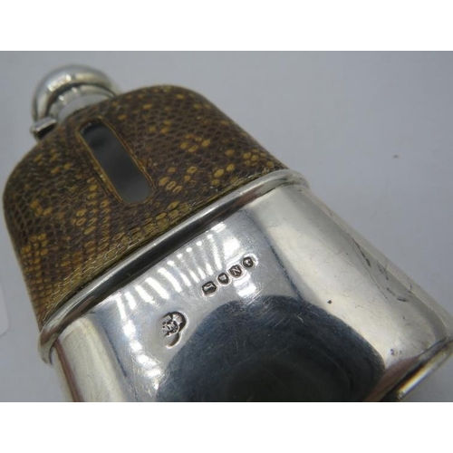 457 - A Victorian silver and snake skin mounted hip flask. London 1888. Monogramed and a panel cut plated ... 