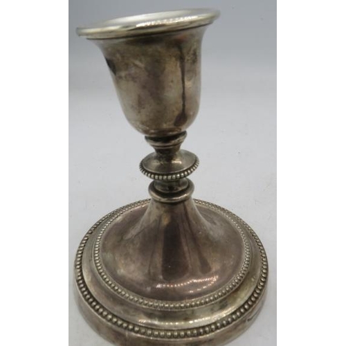 469 - A pair of silver candlesticks with bead edge decoration, approx 5