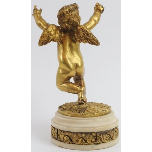 51 - A European ormolu bronze figure of a putti cherub, 19th century. Mounted on an ormulu banded white a... 