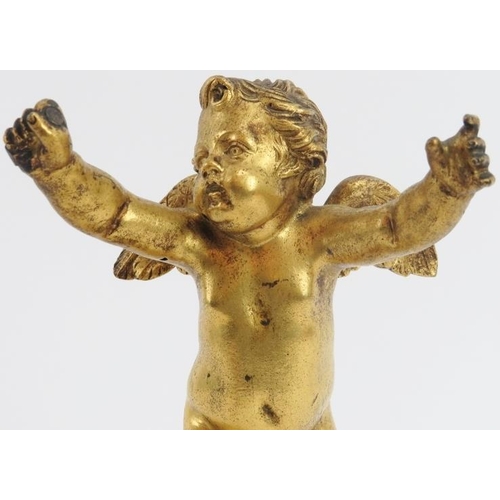 51 - A European ormolu bronze figure of a putti cherub, 19th century. Mounted on an ormulu banded white a... 