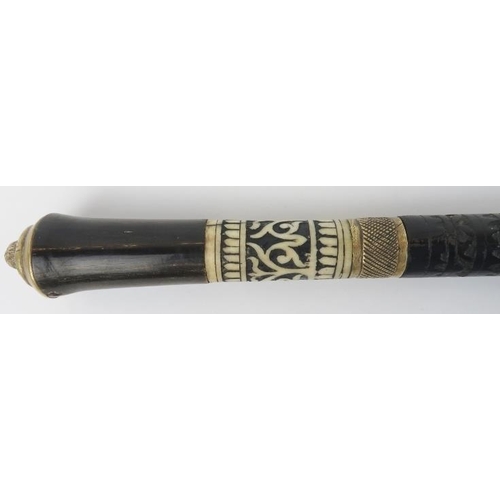 64 - An Anglo Indian ebonised, carved bone and brass mounted sword stick walking cane, late 19th/early 20... 