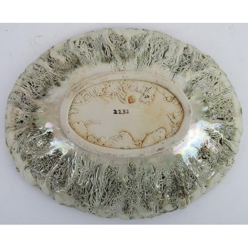 82 - An unusual iridescent pale green majolica bowl, late 19th/early 20th century. Marked EB to the rever... 