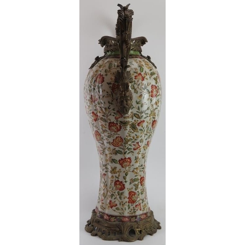 87 - A large French brass mounted porcelain twin handled vase, 20th century. With scrolling foliate mask ... 