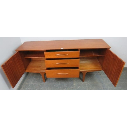 704 - A mid-century teak sideboard by Jentique, having three short drawers flanked by two cupboards with f... 