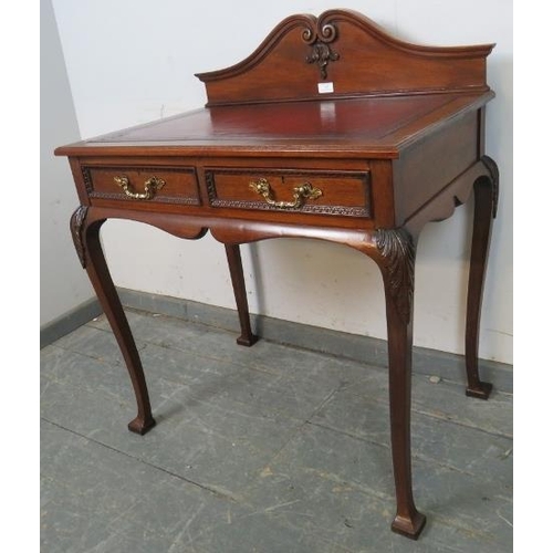 707 - A vintage 19th century style mahogany writing table by Maple & co, with inset burgundy leather writi... 